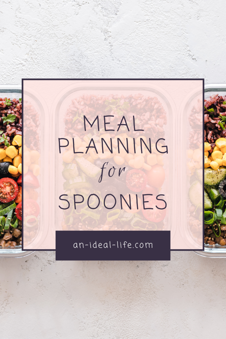 A promotional graphic for “Meal Planning for Spoonies” from an-ideal-life.com. The background features neatly arranged meal prep containers filled with colorful ingredients like grains, vegetables, cherry tomatoes, corn, and leafy greens. A semi-transparent pink overlay contains the text, with a dark purple banner at the bottom displaying the website’s name. The design emphasizes healthy, accessible meal planning for individuals with chronic illnesses.